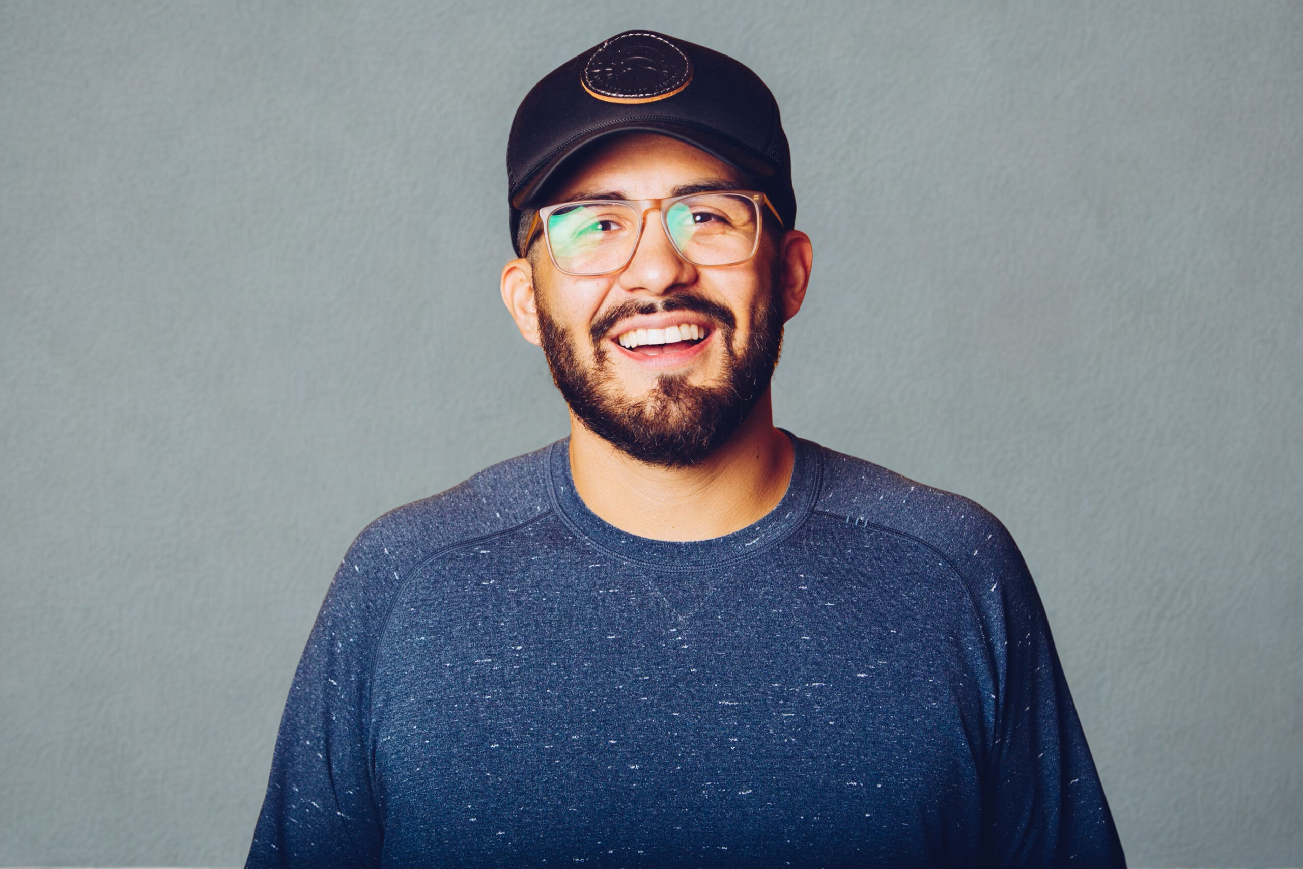 A headshot of a man smiling.