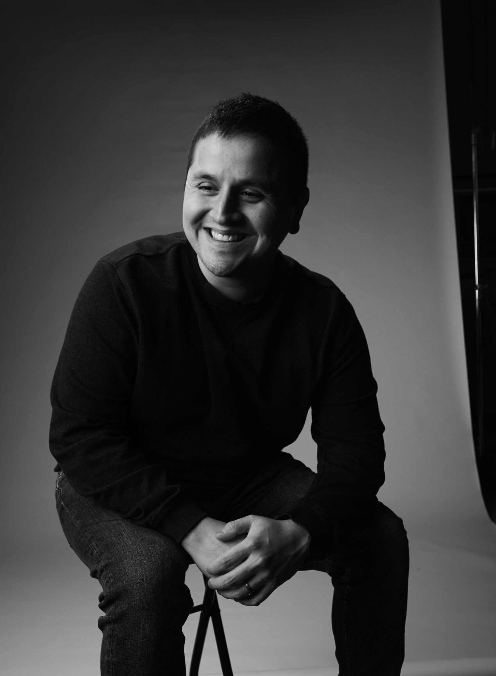A headshot of a man smiling.
