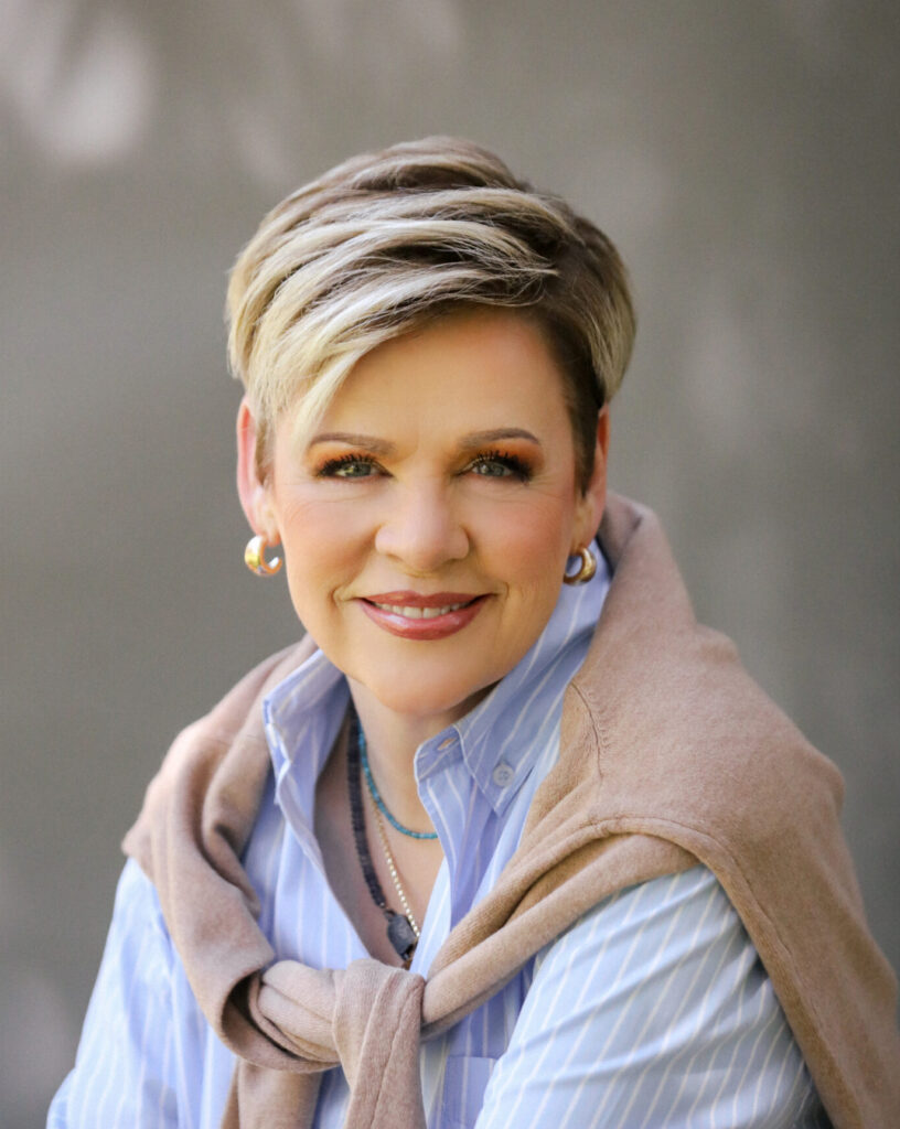 A headshot of a woman smiling.